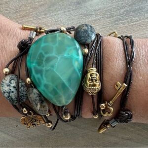 Boho Emerald stone necklace with various charms.